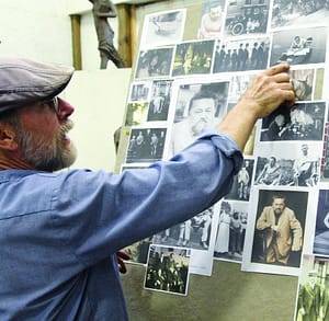 Dexter benedict pointing to photos of Charles Steinmetz on a tackboard.