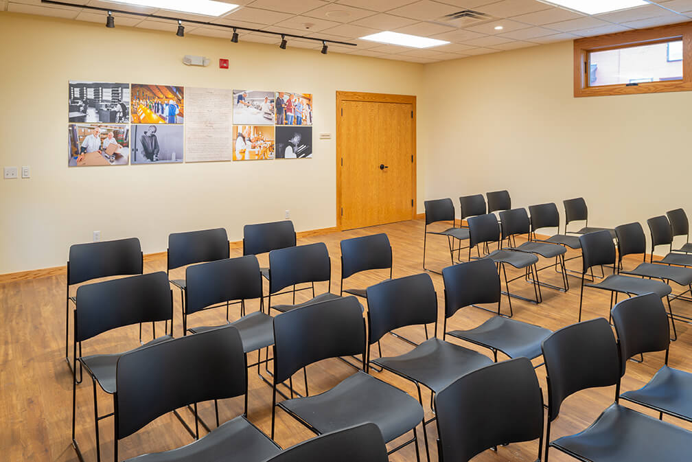 Conference and lecture room for Abbey of the Genesee in Piffard NY with luxury vinyl tile and TakeForm signage