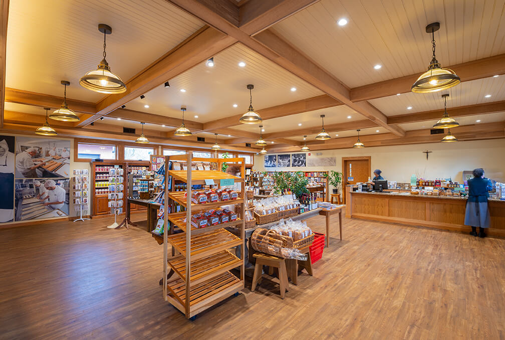 Abbey of the Genesee Piffard NY retail bread store overall view with checkout counter woodwork and dramatic ceiling