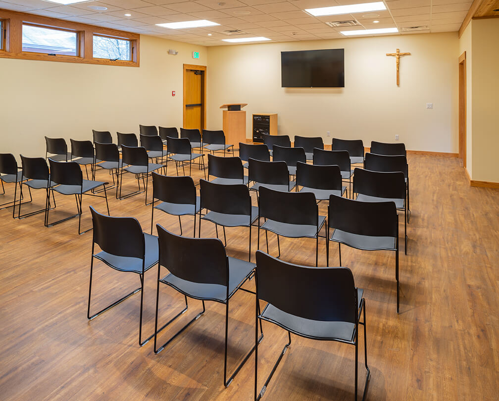 Conference and lecture room at Abbey of the Genesee in Piffard NY with luxury vinyl tile and presentation technology