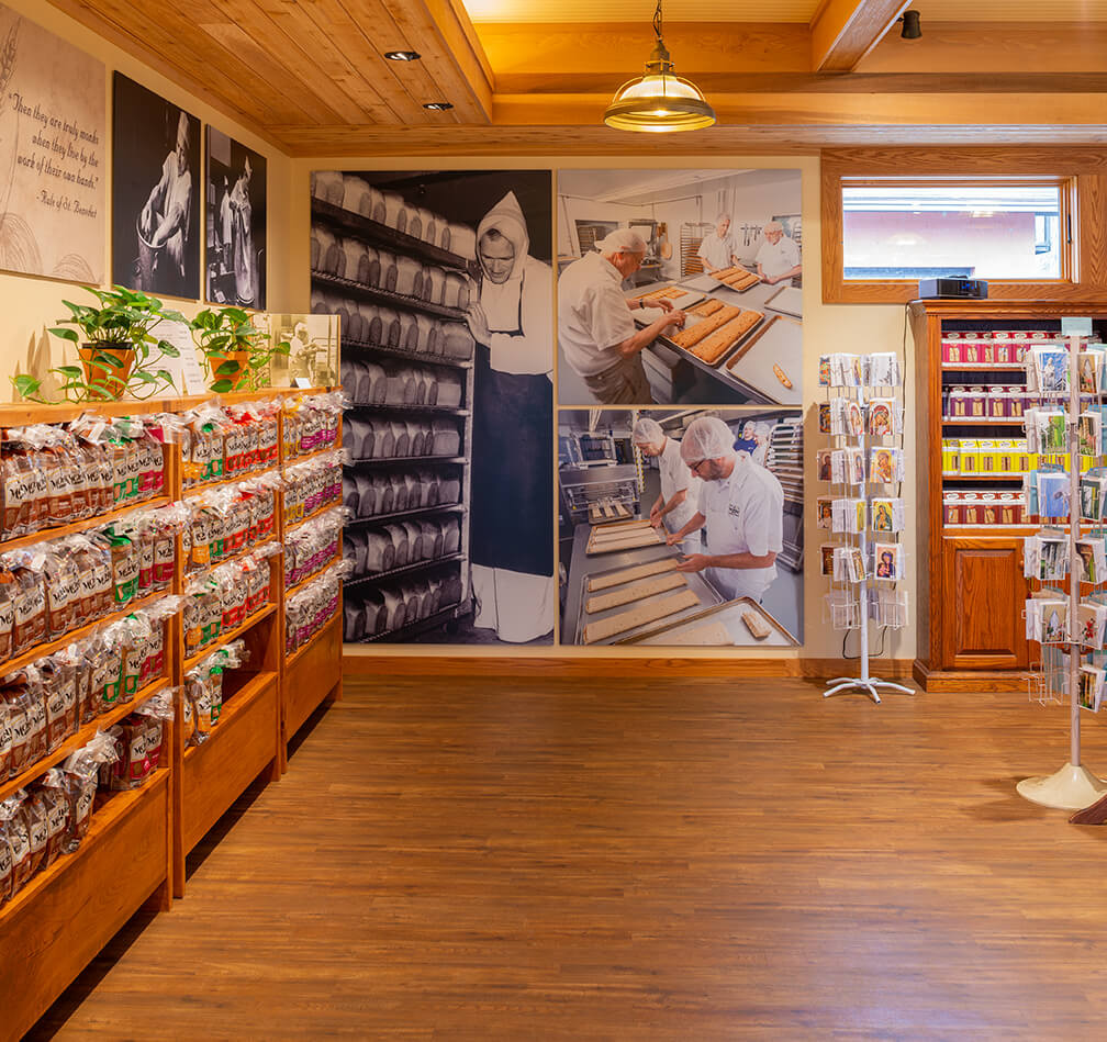Abbey of the Genesee Piffard NY retail store with wood ceiling wood floor and TakeForm signage showing historic monk photos