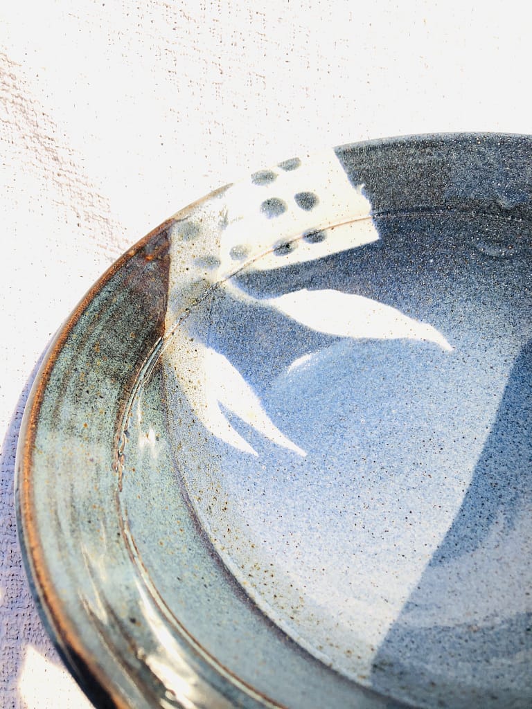 Detailed view of the glaze on a bowl in blue and rutile blue