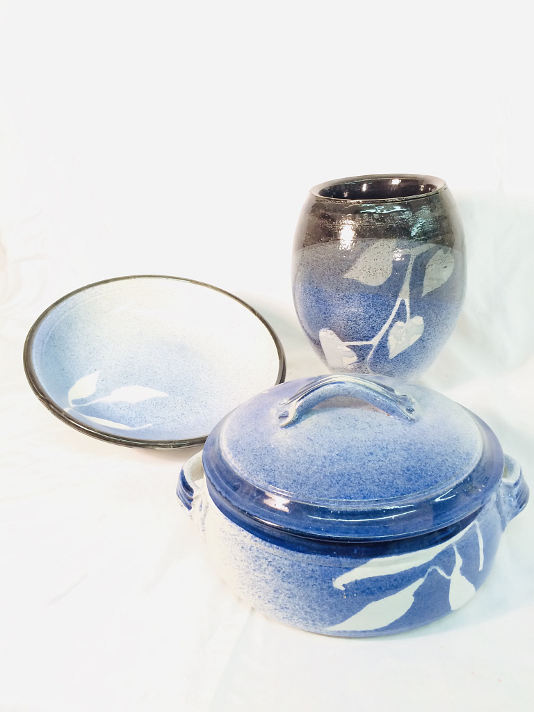 A matching bowl, casserole dish, and oval base glazed with blues and temmoku brown