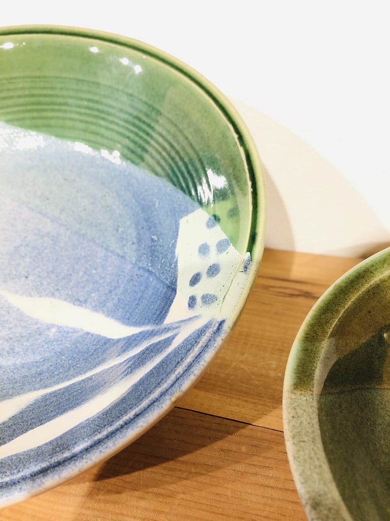 Detail of the glaze on a rim of a blue and green bowl