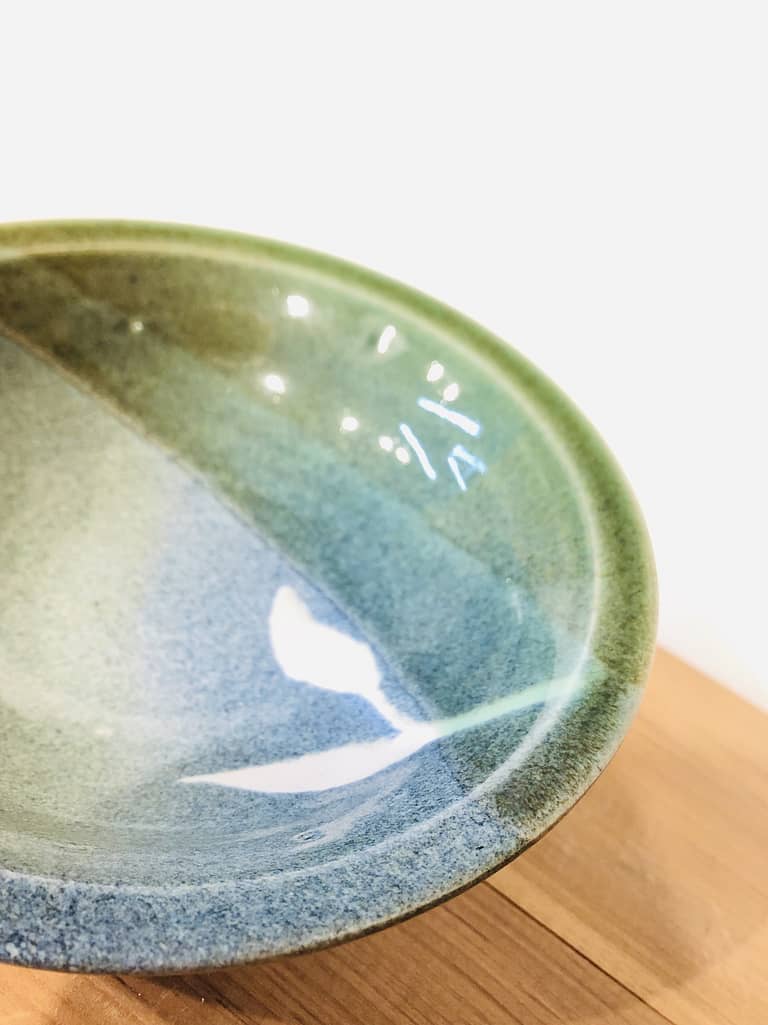 A bowl glazed with blue, green, and turquoise