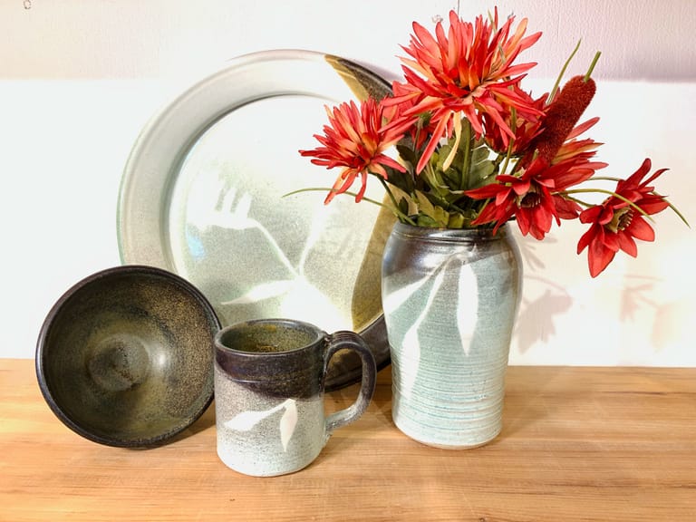 Matching bowl, platter, plate, vase, and mug in green, temmoku, and turquoise glazes
