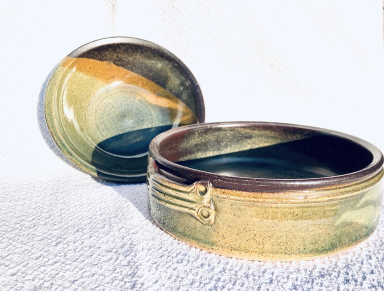 A matching casserole dish and a serving bowl in green and temmoku brown glaze