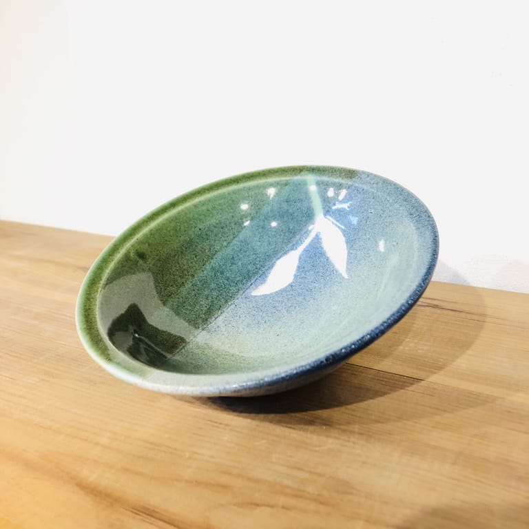 Shallow bowl glazed with greens and blues