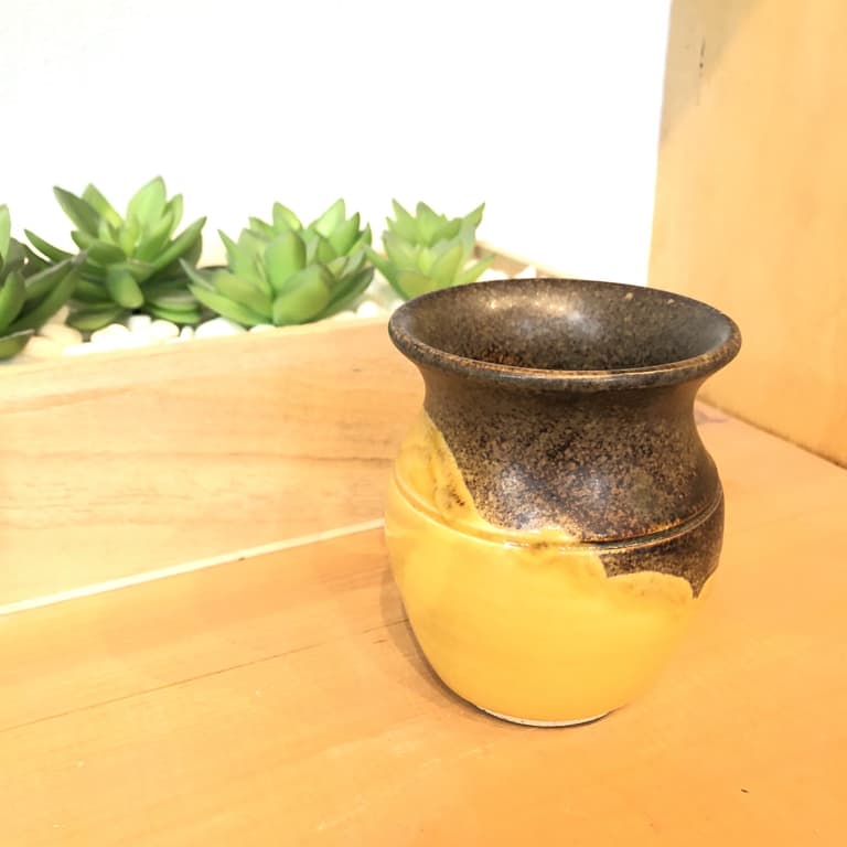 A small vase with a flared rim in bright yellow and temmoku glazes