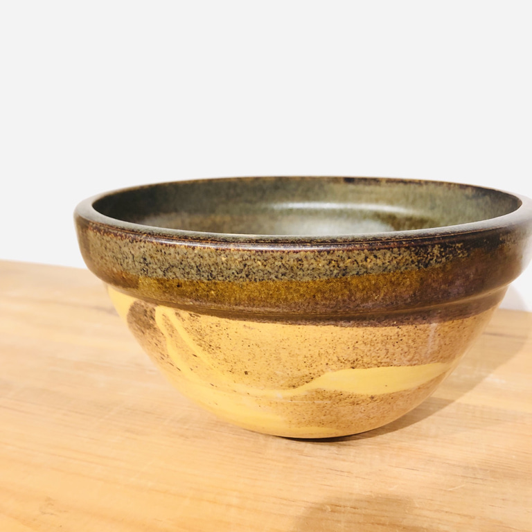 A mixing bowl with an american-style profile glazed in temmoku brown and gold