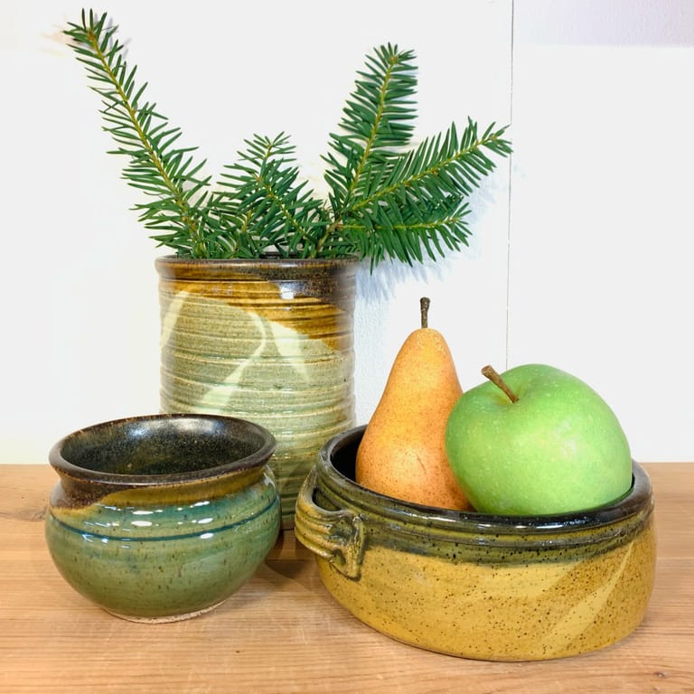 A tall and globe-shaped vase with a small crock in gold, green, and temmoku glazes